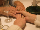 A Family Holds Hands at a Restaurant Photographic Print by Taylor S. Kennedy