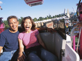 Young Couple Riding Carnival Ride Photographie
