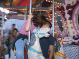 Young Couple Kissing on Carousel Photographic Print