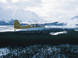 Plane Taking off from Snowy Landscape Photographic Print