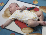 Baby in Yellow and White Sleeper Sleeping on Blanket Photographic Print