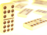Line of Black and White Dominoes Against White Background with Fallen Dominoes Lámina fotográfica