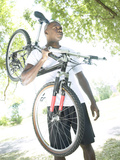 Man Carrying Bike Photographic Print
