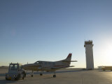 Propeller Airplane Being Pushed by Vehicle on Runway Lámina fotográfica