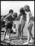 Group of Children Including Girls in Bikinis Inspect Their Net for Fish Photographie