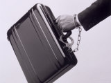 Briefcase with Hand Cuffed to It Photographie par Howard Sokol