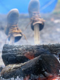 Shoes Drying on Sticks Next to Campfire Photographic Print by Donald Higgs