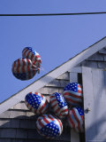 Flag balloons flying out of a small door Lámina fotográfica por Gary D. Ercole