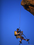Rock Climber Hanging off Cliff Photographic Print by Greg Epperson