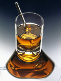 Glass of Liquor with Glass Stick Fotografisk tryk af ATU Studios