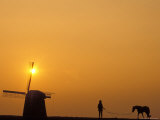 Person with Horse and Windmill at Sunset Photographic Print