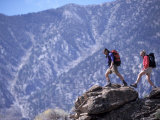 Man and Woman Hiking Over Rocks Lámina fotográfica Man and Woman Hiking Over Rocks Lámina fotográfica