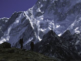 Climbers Passing by Mount Nuptse, Nepal Posters by Michael Brown