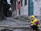 Child Playing on the Street, China Poster by Ryan Ross