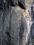 Climber Perched on Large Rock Wall, Madagascar Photographie par Michael Brown