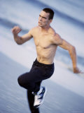 Side Profile of a Young Man Jogging on the Beach Photographic Print