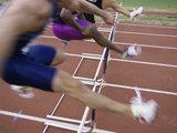 Side Profile of Three People Jumping a Hurdle Lámina fotográfica