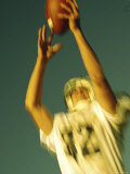 Football Player Reaching Up To Catch a Ball Photographic Print