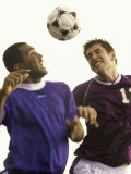 Two Soccer Players Jumping to Head a Soccer Ball Photographic Print