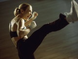 Side Profile of a Young Woman Kickboxing Photographic Print