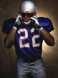 Portrait of an American Football Player Removing His Helmet Photographic Print