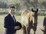 Jockey Standing Next To Two Horses Photographic Print
