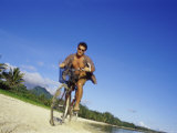 Man Riding a Bicycle on the Beach Photographic Print