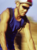 Blurred Image of a Man Cycling Photographic Print
