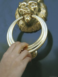 Close-up of a Person's Hand Using a Doorknocker Photographic Print