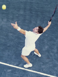 High Angle View of Man Serving a Tennis Ball Photographic Print