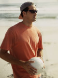 Young Man Holding a Volleyball on The Beach Photographic Print
