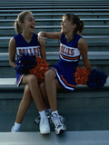 Two Cheerleaders Sitting with Pom-Poms Photographic Print