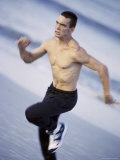 Side Profile of a Young Man Jogging on the Beach Photographic Print