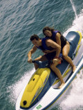 Mid Adult Couple Riding a Jet Ski in the Sea Photographic Print