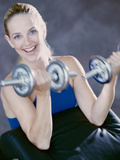 Portrait of a Young Woman Exercising with Dumbbells Photographic Print