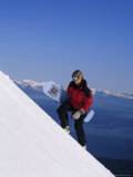 Snowboarder Climbing with Mountainscape Beyond Photographic Print