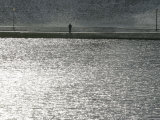A Man Stands on the Banks of a Small Lake, Munich, on Friday, November 3, 2006. Photographic Print by Christof Stache