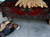 A Beggar Sleeps Next to a Bakery in Kabul, Afghanistan, Wednesday, June 7, 2006 Photographic Print by Rodrigo Abd