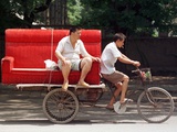 A Chinese Man Rides on a Sofa as Another Pedals a Delivery Tricycle Photographic Print