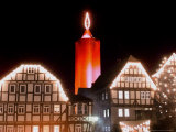 A Huge Christmas Candle Appears Above the Roofs in the Old City of Schlitz, Germany Photographic Print by Heribert Proepper