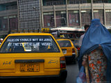 An Afghan Woman Clad in a Burqa Walks Next to a Taxi in Kabul, Afghanistan, Wednesday, June 7, 2006 Photographic Print by Rodrigo Abd
