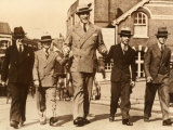 An Extremely Tall Man Seen in the Middle of Four Men of Normal Height Photographic Print