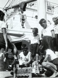 On the Deck of a Ship, a Boy Acts as a Shoeshine Around Him, Other Boys in Sailor Clothes Photographic Print