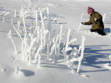 A Young Boy Wades Through the Deep Snow Photographic Print by Christof Stache