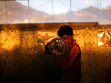 A Young Afghan Man Exercises with a Barbell in Kabul Photographic Print