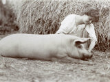 Young Peasant-Woman Kneeling Down Beside a Small Pig Photographie