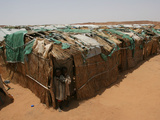 Two Sudanese Boys Stand by Makeshift Huts Photographic Print