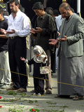 Iraqis, Inluding a Little Girl, Pause to Pray Photographic Print
