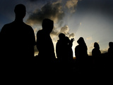 Several Africans Immigrants Chat at Sunset Outside of the Holding Centre for Immigrants Photographic Print