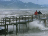 Pedestrians Walk on a Pier During Heavy Storms on Lake Chiemsee Photographic Print